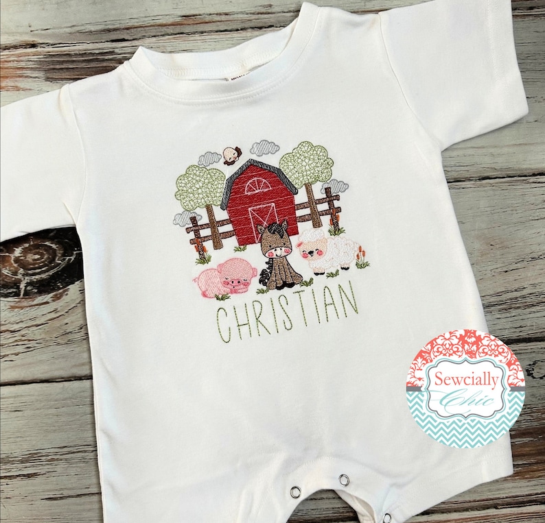 May include: White baby onesie with an embroidered farm scene featuring a red barn, a horse, a pig, and a sheep. The onesie has the name "CHRISTIAN" embroidered below the farm scene.