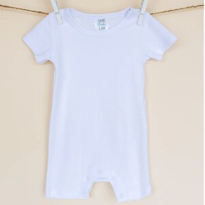 May include: White short-sleeve baby onesie with a tag that reads "100% Blanks 3-6M".