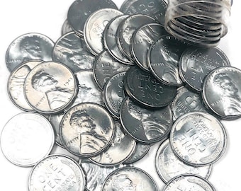 May include: A pile of silver-colored US one-cent coins with the inscription "ONE CENT" and "UNITED STATES OF AMERICA". The coins are from different years, including 1942, 1943, and 1947.