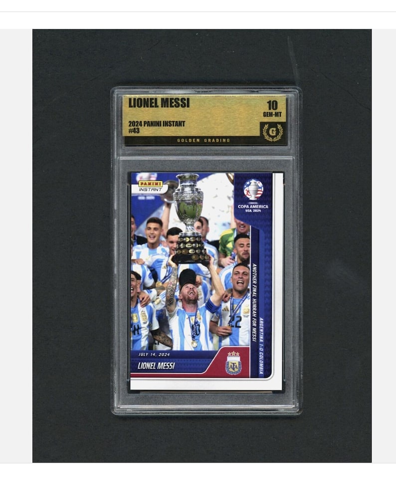 May include: A graded Lionel Messi 2024 Panini Instant card. The card features Messi holding a trophy with teammates, celebrating a victory. The card is graded 10 GEM-MT by Golden Grading.