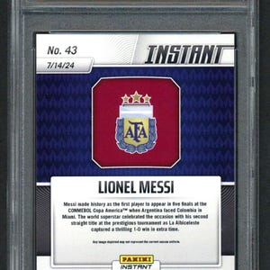 May include: A graded Lionel Messi Panini Instant card. The card features the Argentina national team logo and text that reads "Lionel Messi." The card is encased in a protective holder with "Golden Grading" and a serial number.