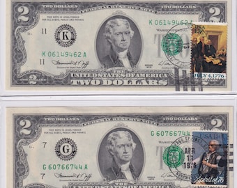 May include: Two $2 bills with a green seal and a stamp featuring a scene from the signing of the Declaration of Independence. The stamp on the top bill reads "July 4, 1776" and the stamp on the bottom bill reads "Spirit of '76".