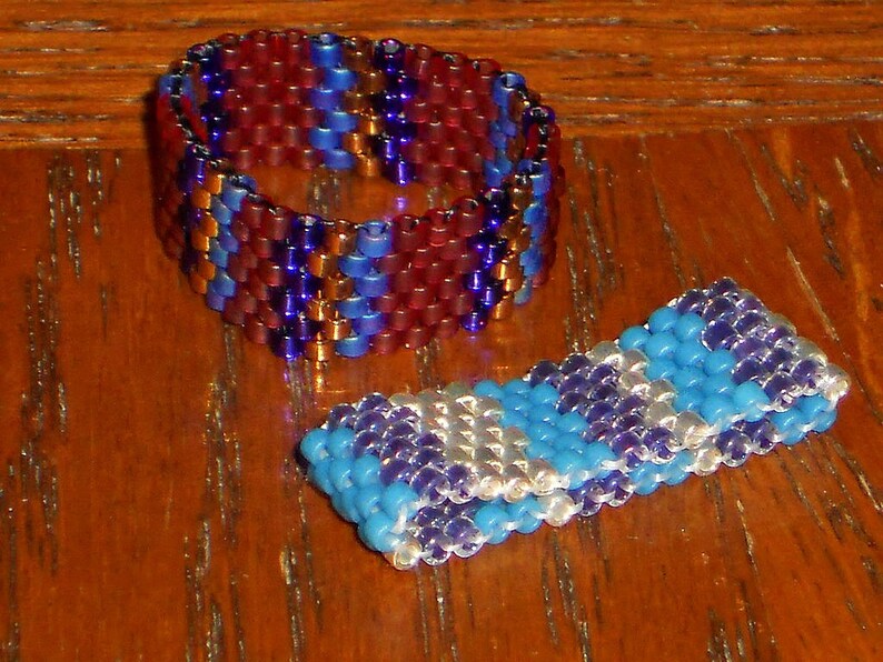 May include: Two beaded rings, one with red, blue, and purple beads, and the other with blue, purple, and white beads.