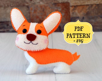 May include: A felt plush toy of a corgi dog in orange and white. The toy has a stitched smile and black eyes. The image includes the text "PDF PATTERN + SVG".