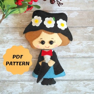 Puede incluir: Patrón PDF para una muñeca de fieltro con un sombrero negro, cabello castaño y un vestido azul. La muñeca sostiene un paraguas negro y tiene una corbata de lazo roja.