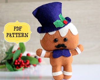 May include: A felt gingerbread man toy wearing a blue top hat with green holly and a red berry. The gingerbread man has a white icing beard, brown eyes, a black mustache, and a blue bow tie.