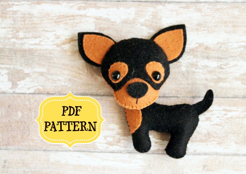 May include: PDF pattern for a felt chihuahua toy. The chihuahua is black with brown ears and a brown nose. The pattern is available for download.