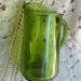 Pitcher of green depression glass