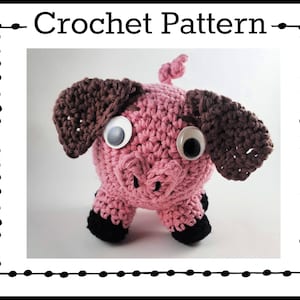 Puede incluir: Un cerdo rosa de crochet con orejas marrones y patas negras. El cerdo tiene grandes ojos saltones.