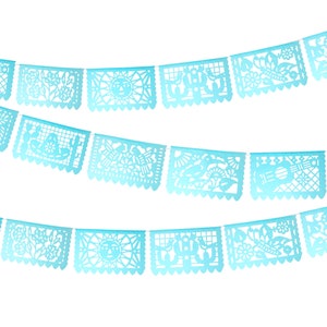 May include: A string of blue paper cutouts, known as papel picado, with various designs, including a guitar, a sun, a cactus, and birds. The cutouts are strung together with white string and are hanging against a white background.