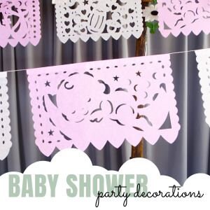 May include: Pink and white paper cutouts with a baby theme, including a baby, stars, and moons. The cutouts are strung together to form a banner that says "BABY SHOWER party decorations".