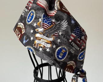 May include: Gray scrub cap featuring patriotic imagery, including an American flag, an eagle, and the text "AIM HIGH FLY - FIGHT-WIN." The cap also displays military emblems and the words "FREEDOM OVER FEAR."