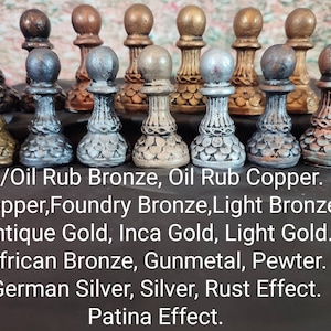 May include: A collection of decorative pawn chess pieces in various metallic finishes, including bronze, copper, and silver. The image displays a variety of colors and textures, with text indicating the different finishes available, such as "Oil Rub Bronze" and "Patina Effect."