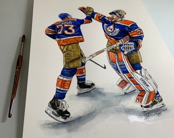 May include: Watercolor painting of two hockey players in action. The player on the left is wearing a blue and orange jersey with the number 73 and the name "Arnais" on the back. The player on the right is wearing a blue and orange jersey with the number 74 and the text "Edmonton Oilers" on the front. The goalie is in a catching position with his glove raised.