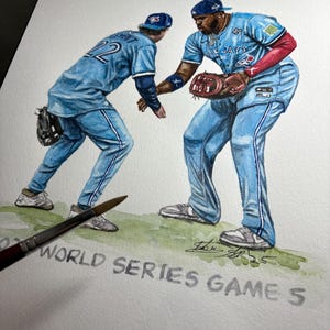 May include: Watercolour painting of two baseball players in light blue uniforms, one with the number 22. The text "WORLD SERIES GAME 5" is visible. The players are wearing baseball caps and gloves. The painting is on white paper.