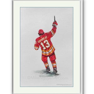 May include: Watercolor painting of a hockey player wearing a red and yellow jersey with the number 13 and the name "GAUDREAU" on the back. The player is raising his stick in the air, celebrating a goal.