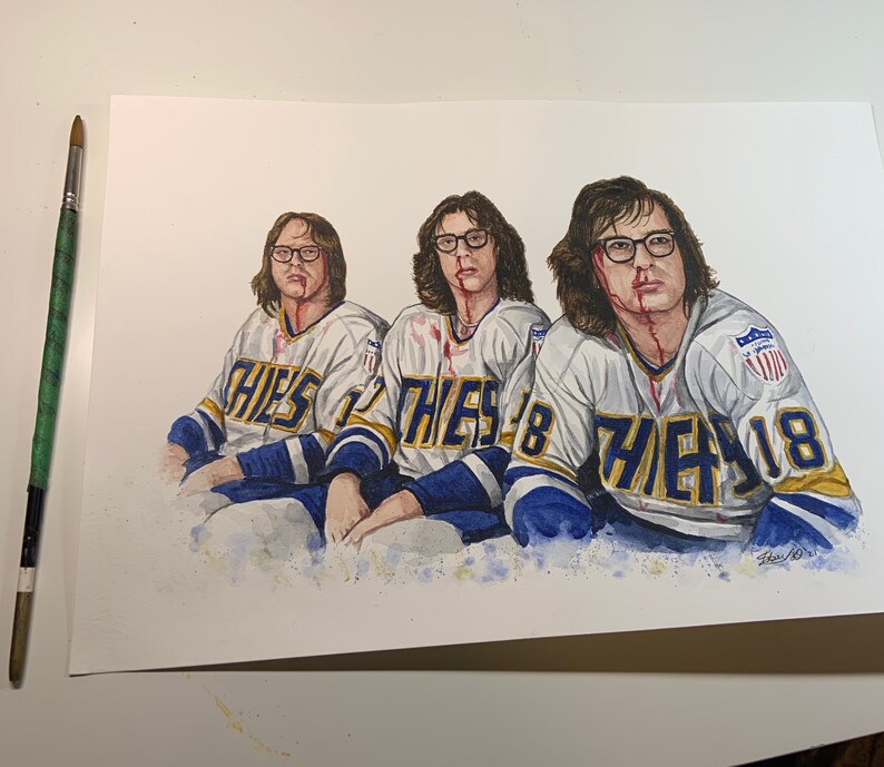 May include: Watercolor painting of three hockey players wearing blue and white jerseys with the word "THEYS" on the front. The players have blood on their faces and are looking at the viewer.