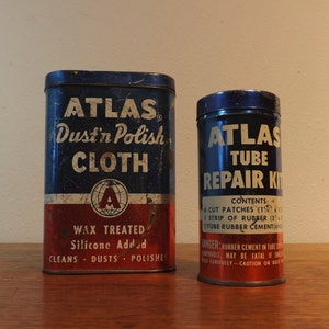 May include: Two vintage metal tins with blue and red labels. The larger tin is labeled "ATLAS Dust'n Polish CLOTH WAX TREATED Silicone Added CLEANS DUSTS POLISHES". The smaller tin is labeled "ATLAS TUBE REPAIR KIT CONTENTS: 6 CUT PATCHES (1 1/2" x 1 1/2") 1 STRIP OF RUBBER (3' x 1/2") 1 TUBE RUBBER CEMENT (3/4 oz.) DANGER: RUBBER CEMENT IN TUBE IS INFLAMMABLE MAY BE FATAL IF SWALLOWED READ CAREFULLY - CAUTION ON BACK"