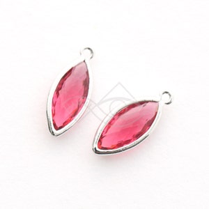 May include: Two marquise-shaped, ruby-colored gemstone pendants with a silver-colored metal frame. Each pendant has a small loop at the top for attaching to a chain or other jewelry component. The gemstones have a faceted cut.