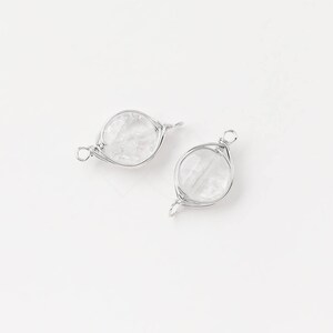 May include: Two silver wire wrapped clear quartz crystal beads with loops for attaching to jewelry.