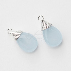 May include: Two light blue teardrop-shaped gemstone pendants with silver wire wrapped around the top.