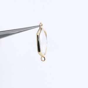 May include: Gold-toned metal pendant with a clear glass octagon-shaped bezel. The pendant has a loop at the top and a jump ring at the bottom.