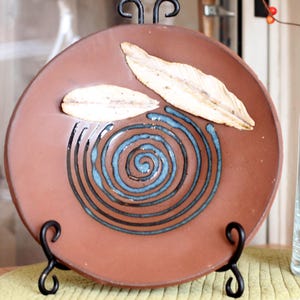 Handmade ceramic birdbath with sculpted feather accent