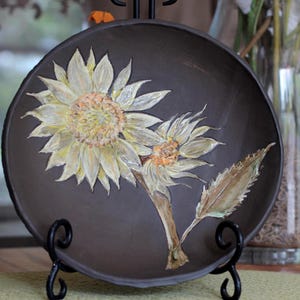 Handmade ceramic birdbath made from espresso brown stoneware clay with handcarved sunflower motif