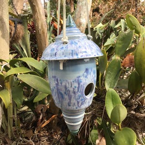 Handmade ceramic birdhouse with leather strapping
