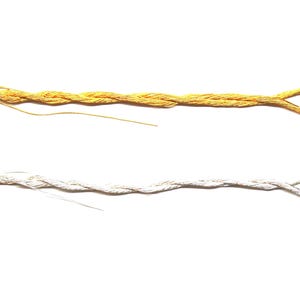 May include: Two skeins of metallic thread, one gold and one silver, are displayed against a white background. Each thread is looped at one end and has a tag that reads "Kreink Japan Thread #5".
