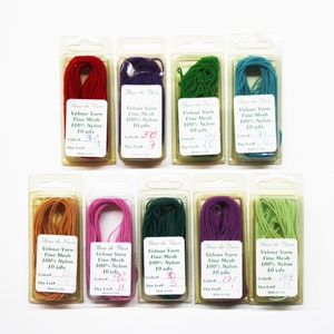 May include: Ten spools of velour yarn in various colors, including red, purple, green, teal, orange, pink, dark green, purple, and light green. Each spool is labeled "Heur de Paris Velour Yarn Fine Mesh 100% Nylon 10 yds." with a color number and dye lot number.