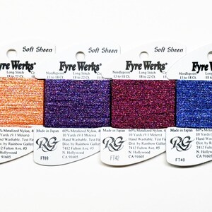 May include: Six spools of Fyre Werks Soft Sheen embroidery floss in various colors, including burgundy, orange, purple, red, blue, and lavender. Each spool is labeled with the brand name, thread type, and yardage.