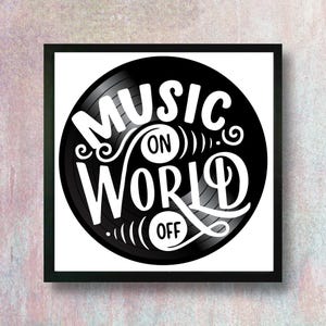 May include: A black and white framed print featuring a vinyl record design. The artwork displays the words "Music On World Off" in a stylized font. The background is white, and the frame is black.