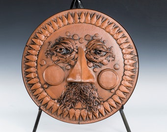 18" "Old Man Sun" Plaque - Red clay with metal frame for hanging.