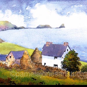 May include: Watercolour painting of a white cottage with a blue roof, surrounded by stone walls and green grass. The cottage is situated on a hillside overlooking a body of water with islands in the distance. The sky is a light blue with white clouds.