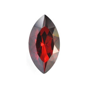 May include: Marquise-cut gemstone in a deep red colour. The faceted surface reflects light, highlighting the gem's clarity and brilliance. The elongated shape and rich colour suggest it could be a garnet or ruby, suitable for jewellery.