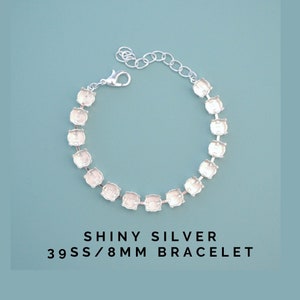 May include: Shiny silver bracelet with square settings. The bracelet has a lobster clasp closure and an adjustable chain. The text on the image reads "Shiny Silver 39SS/8MM Bracelet".