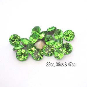 May include: A group of green rhinestones in various sizes, including 29ss, 39ss, and 47ss.