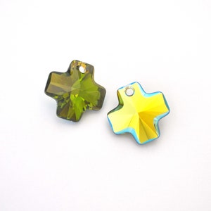 May include: Two crystal cross charms, one green and one yellow, with a hole at the top for hanging.
