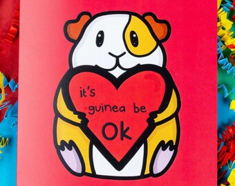 May include: A red card with a cartoon guinea pig holding a heart that says "it's guinea be ok".