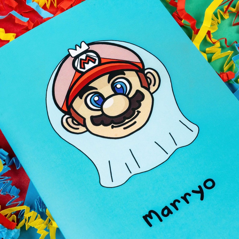 Marryo - Mario Engagement Wedding Card on red, blue & green card with crinkle card confetti. Blue a6 congratulations card of a smiling nintendo mario character head wearing a white bridal wedding veil, underneath him is black text reading Marryo.