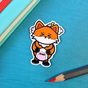 PMDD Fox Sticker Premenstrual Dysphoric Disorder on blue. Orange fox has shut eyes with storm clouds above its head, clutching its pink belly with black text reading PMDD. Hhand drawn design is raising awareness for Premenstrual Dysphoric Disorder.