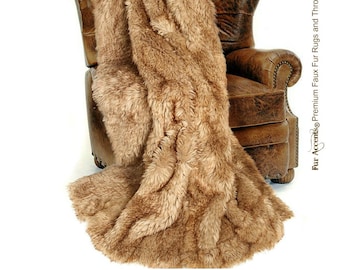 May include: A soft, brown faux fur throw blanket draped over a leather armchair. The blanket is made of plush, fluffy material and has a luxurious feel.
