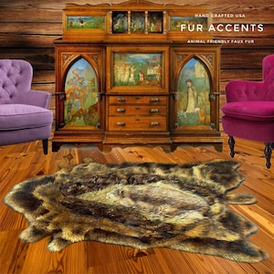 May include: A brown faux fur rug with a shaggy texture. The rug is laid out on a wooden floor in front of an antique cabinet with intricate carvings. The cabinet has glass doors with painted scenes and drawers. The text "HAND CRAFTED USA FUR ACCENTS ANIMAL FRIENDLY FAUX FUR" is displayed above the cabinet.