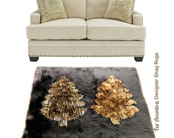 Puede incluir: Una alfombra de piel sintética gris con dos árboles de piel marrón y dorado en el centro. La alfombra está sobre un fondo blanco. Fur Accents® Designer Shag Rugs.