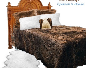 May include: A brown faux fur bedspread with white faux fur pillows and a white faux fur throw rug. The bed has a wooden headboard with intricate carvings. The text "FUR ACCENTS Handmade in America" is visible in the top right corner of the image.