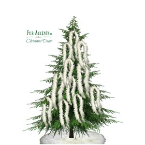 May include: A green Christmas tree decorated with white feather garland. The garland is arranged in a cascading pattern around the tree. The text "Fur Accents Christmas Decor" is visible in the top left corner of the image.