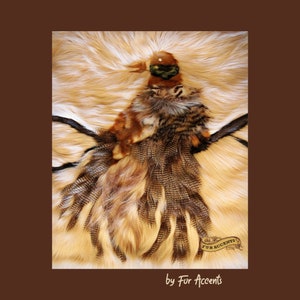 May include: A brown and tan faux fur bird with a green head and black eyes. The bird is sitting on a light brown faux fur background. The text "Fur Accents" is in a brown circle with a gold border.