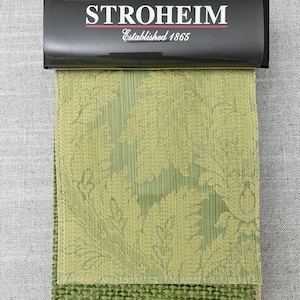 May include: A fabric swatch sample with a green and yellow floral pattern. The fabric is labeled "STROHEIM Established 1865".