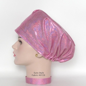 May include: A pink, iridescent Euro Style fabric cap with a matching collar. The cap is designed with a rounded crown and a brim. The text "Euro Style Fabric #S729" is visible on the collar. The fabric has a shimmering, textured appearance.